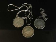Three silver coin pendants to include a 1900 Crown,