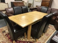A contemporary light oak extending dining table together with six brown leather chairs