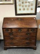 A George III mahogany bureau on bracket feet