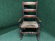 An antique mahogany child's rocking chair