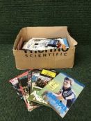 Two boxes of football programmes