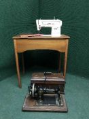 A Singer sewing machine in case and cased machine