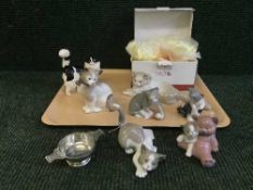 A collection of seven Nao and Lladro cats, one boxed,