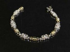 An 18ct yellow and white gold diamond set bracelet 18 grams, .