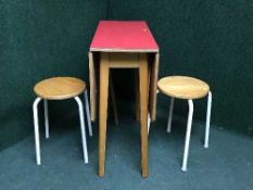 A melamine topped table and two stools