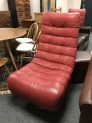 A red leather contemporary swivel lounge chair