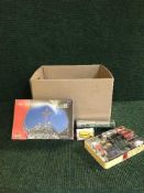 A box of miniature vehicles and boxed toy cars