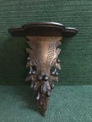 A late 19th century heavily carved mahogany wall bracket