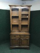 A Stag glazed door bookcase