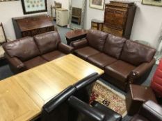 A brown leather three seater settee together with matching two seater and cube footstool (3)