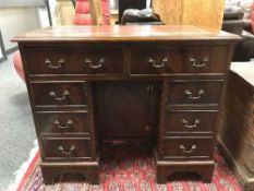A Georgian style mahogany lady's desk with red tooled leather top