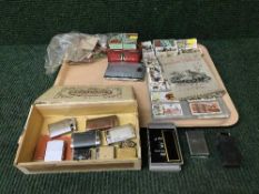 A tray of cigarette cards, lighters,