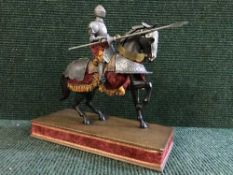 A figure of a knight on horse back