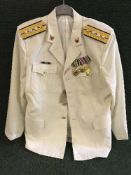 A white Chinese naval jacket with badges and medals