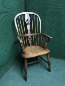 An oak high back Windsor style armchair