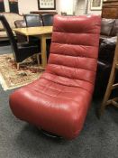 A red leather contemporary swivel lounge chair