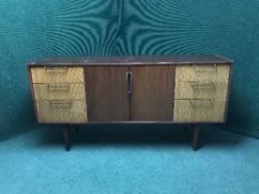A teak low sideboard fitted six drawers