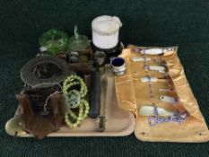 A tray of plated pieces, scent bottles, wall clock, coin,