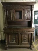 A late 19th century heavily carved oak buffet sideboard
