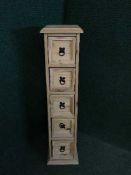 A narrow pine five drawer chest containing CDs