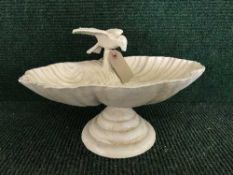 A cast metal bird bath