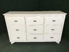 A white nine drawer chest