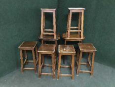 Two mahogany occasional tables and six stools