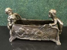 A bronze planter modelled with three cherubs and with embossed decoration to sides depicting