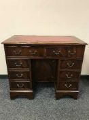 A Georgian style mahogany kneehole desk with leather top