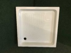 A square ceramic shower tray