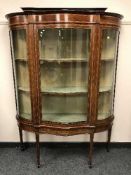 An Edwardian inlaid mahogany serpentine fronted display cabinet