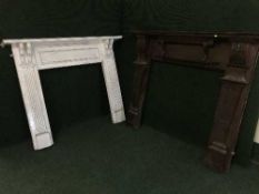 A carved mahogany fire surround and a painted fire surround