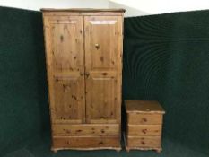 A pine double door wardrobe and a bedside chest