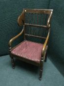 A late 19th century mahogany scroll arm armchair