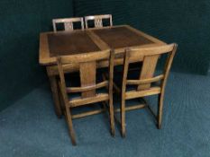 A 1930's oak six piece dining room suite