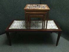 A Danish mahogany tiled topped coffee table and a nest of teak tiled topped tables