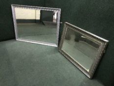 A silvered framed mirror and one other