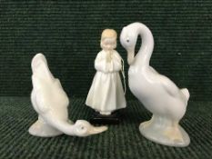 A Royal Doulton figure - Bed time HN 1978 and two Nao swans