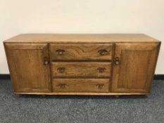 An Ercol elm low sideboard