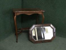 A shaped occasional table and an oak framed mirror