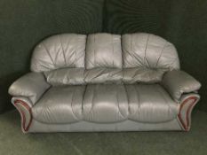 A green leather three piece suite