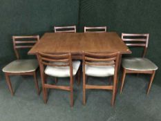 An eight piece teak dining room suite
