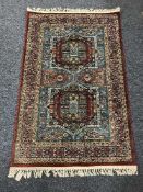 A fringed Persian rug of geometric design