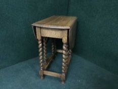 An oak barley twist gate leg table