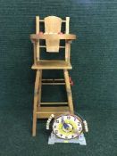 A mid 20th century wooden child's high chair and a clock