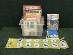 A box of books relating to football and set of Hartleys Footballer Jam jar lids