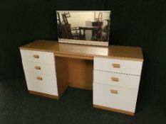 A three piece contemporary bedroom suite comprising of kneehole dressing table,