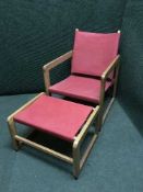 A teak garden armchair with stool