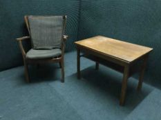 A mid 20th century teak elbow chair and a coffee table
