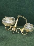 A pair of three way brass light fittings